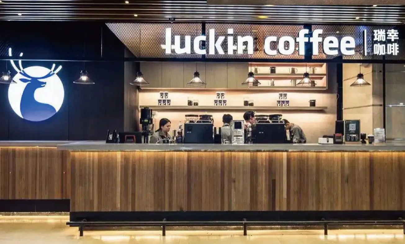 Luckin Coffee store counter with timber cladding and the brand's illuminated signage