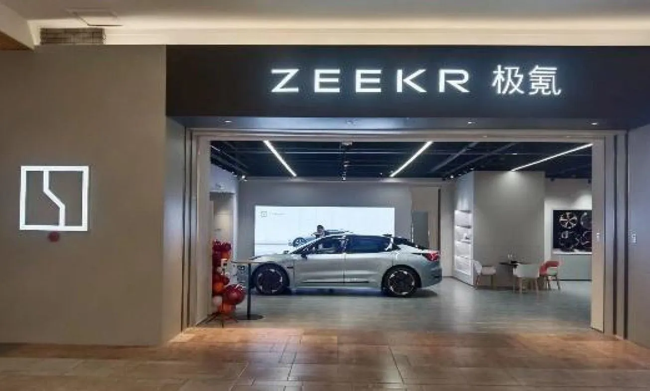 ZEEKR experience centre entrance with illuminated signage and a vehicle on display