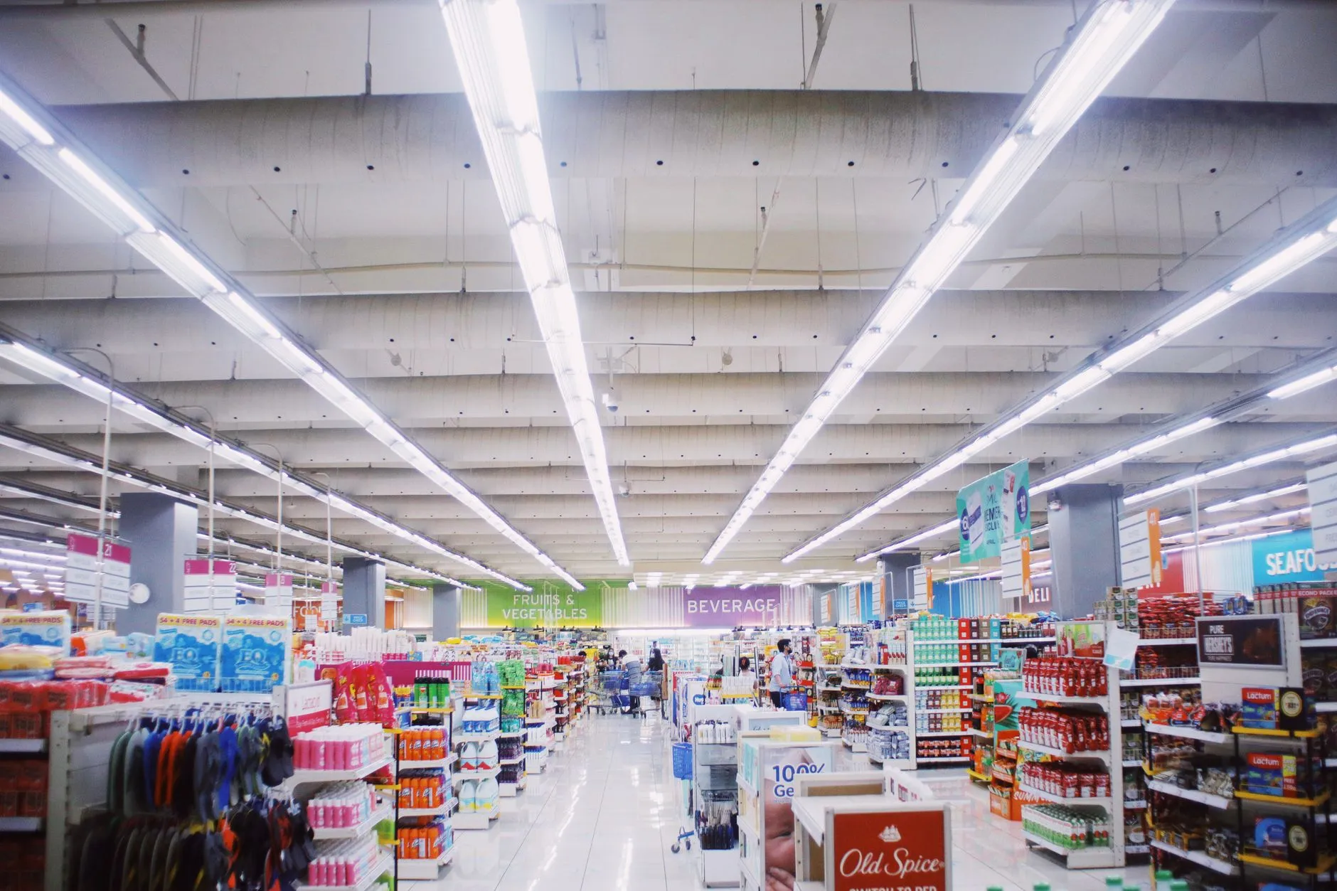 Supermarket aisles under bright lighting